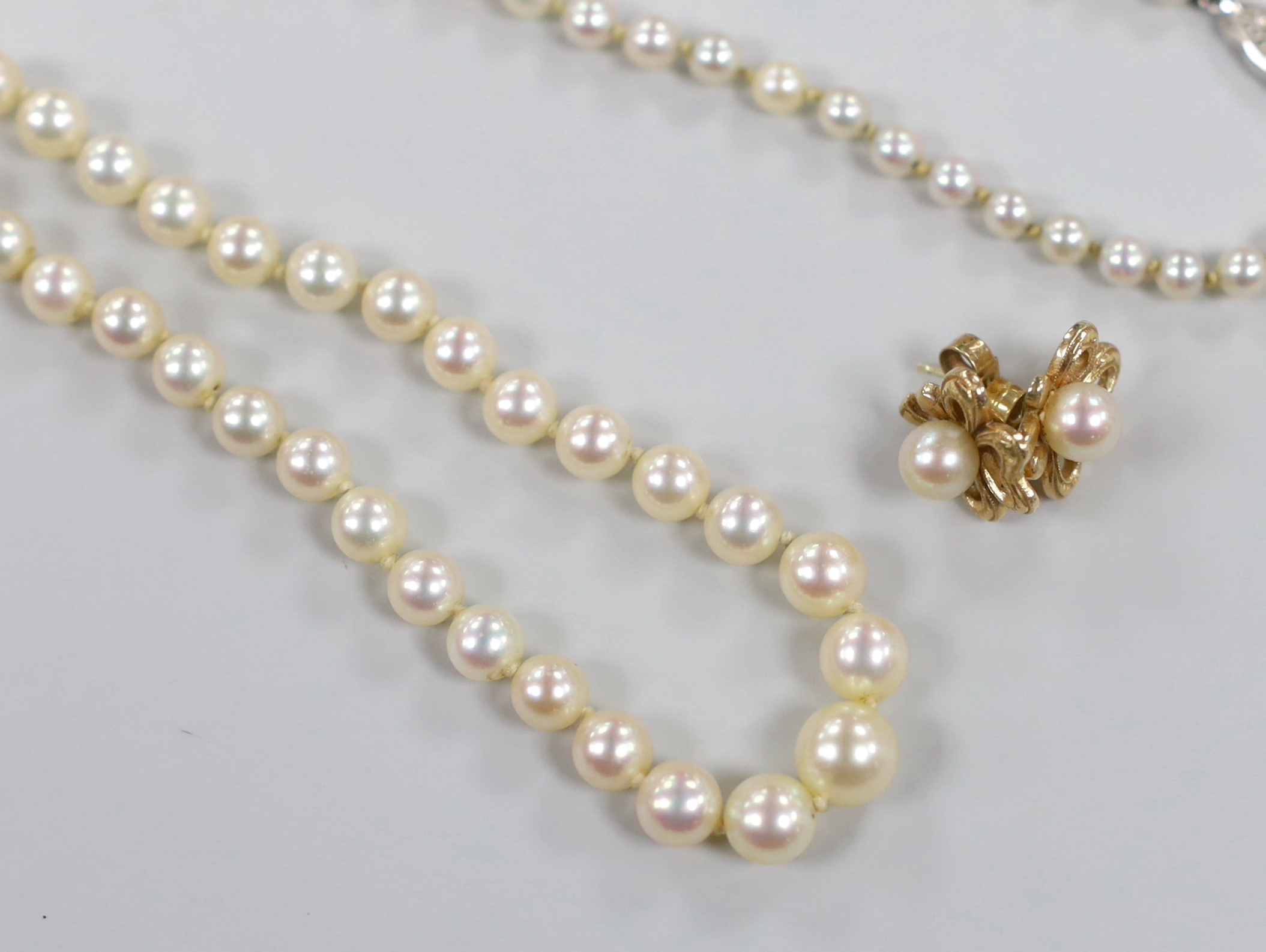 A single strand graduated cultured pearl necklace with 9ct clasp, 50cm and a pair of 375 and cultured pearl ear studs.